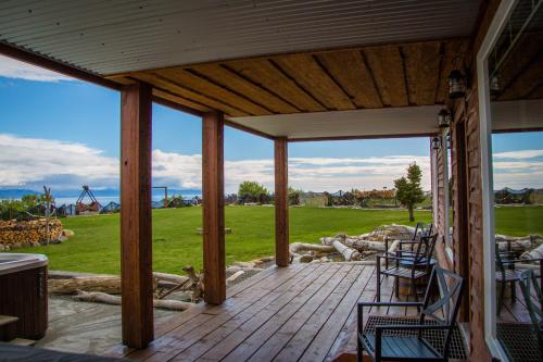 a porch with chairs and a view of a field at Baycrest Lodge in Homer