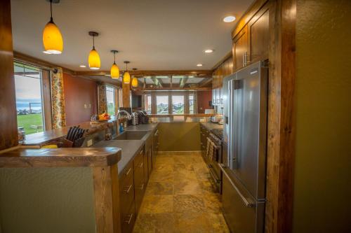 a large kitchen with stainless steel appliances at Baycrest Lodge in Homer