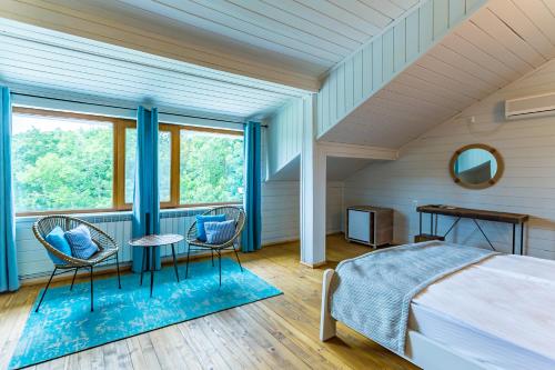 a bedroom with a bed and a table and chairs at St Anastasia Hotel in Burgas