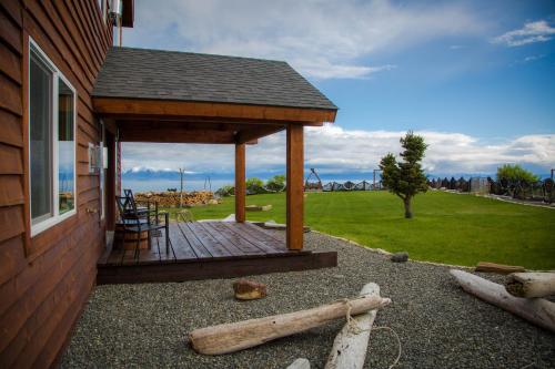 a wooden deck on the side of a house at Baycrest Lodge in Homer
