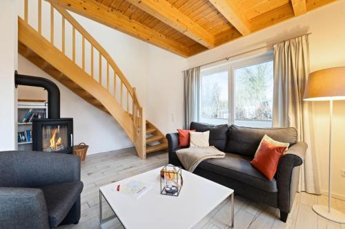 a living room with a couch and a fireplace at Rapsblütenhaus in Bohnert