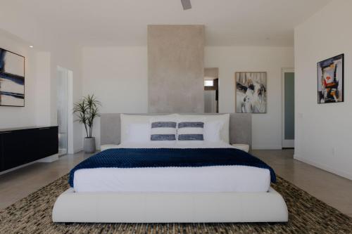 a large white bedroom with a large white bed at Orchid by Fieldtrip Architectural Estate w Pool Spa Game Room in Yucca Valley