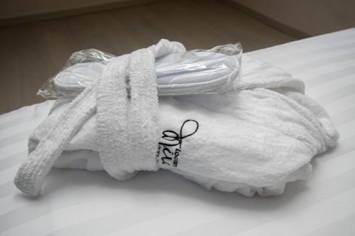 a towel with a name on it sitting on a bed at Locanda Mirei in Finale Ligure