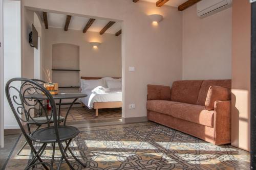 a living room with a couch and a table at Locanda Mirei in Finale Ligure