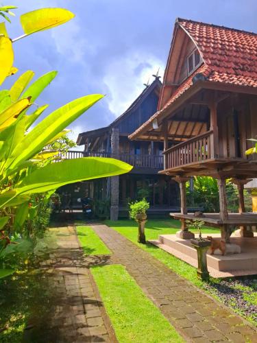 a house with a pathway in front of it at Rumah Kayu Sari in Mengwi
