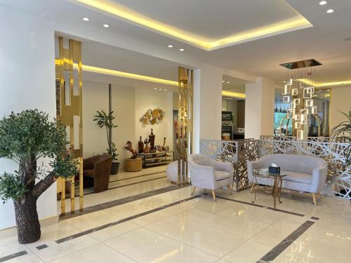 a lobby with chairs and a table in a building at Mass Paradise Hotel in Aqaba