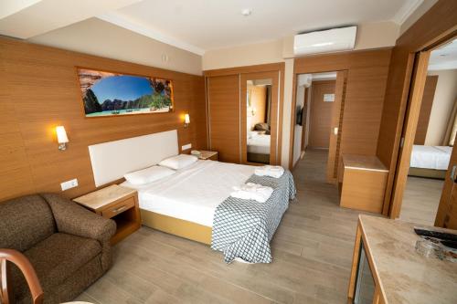 a hotel room with a bed and a couch at Casa Solada Cunda Resort & Spa in Ayvalık