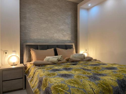 a bedroom with a large bed and two lamps at Behind the Parliament Building in Tbilisi City