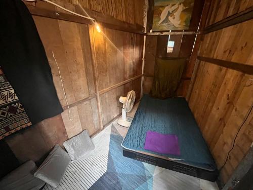 an inside view of a small bathroom with a purple box at Cactos Chill & Homestay in Ho Chi Minh City