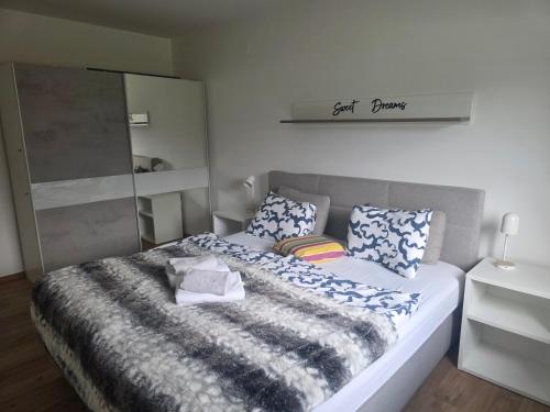 a bedroom with a bed with a blanket on it at Apartment Amy in Podčetrtek
