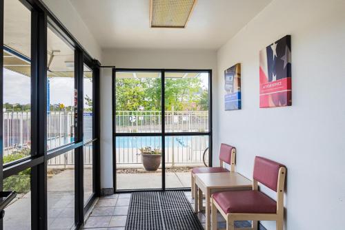 a room with a table and two chairs and a balcony at Motel 6-Rochester, MN in Rochester
