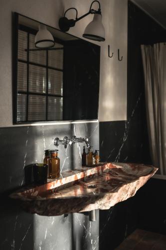 a counter in a kitchen with two lights and a sink at Auberge de la Roche in Valdeblore