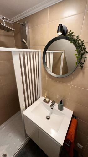 a bathroom with a white sink and a mirror at Alfama OverTheTejo in Lisbon