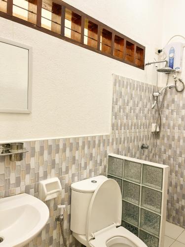 a bathroom with a toilet and a sink at Surfside Bungalows in General Luna