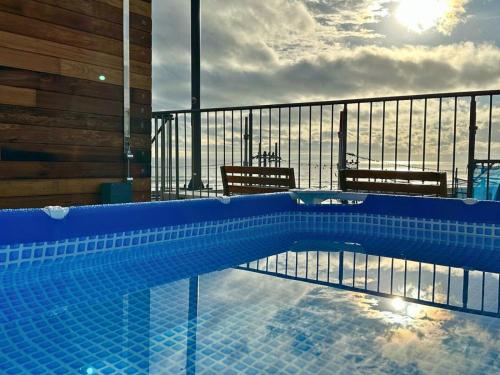 a swimming pool with a view of the ocean at MARSOL CS Beach Hotel in Chigasaki