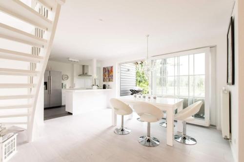 a kitchen and dining room with a white table and chairs at Carpe Deimern in der Lüneburger Heide in Soltau