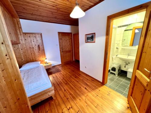 a bedroom with a bed and a sink in a room at Ferienhof Stanzl in Rappottenstein