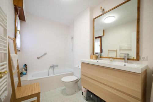 a bathroom with a sink and a toilet and a mirror at LOS RESPIGOS PLAYA in Laredo