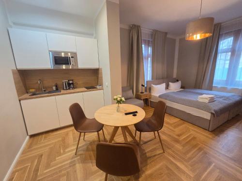 a bedroom with a bed and a table with chairs at Alter Bahnhof Stötteritz in Leipzig
