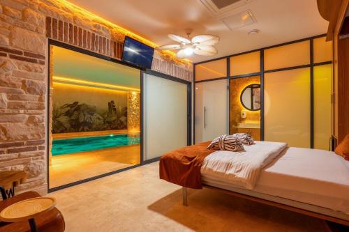 a bedroom with a bed and a brick wall at Emirtimes Hotel&Spa - Tuzla in Istanbul
