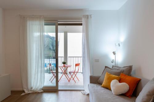 a living room with a couch and a sliding glass door at Nolo Town Luxury Place in Milan