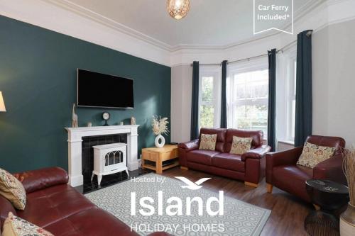 a living room with a couch and a fireplace at Kenmare Cottage in Shanklin