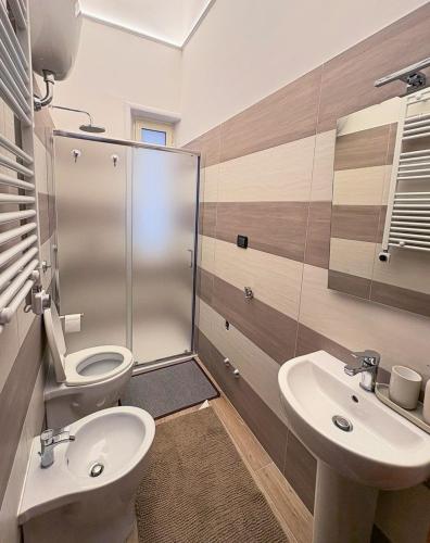 a bathroom with a toilet and a sink at Milion's House Apartments in Salerno