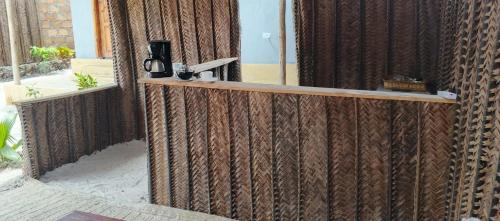 a wooden fence with a mirror on top of it at Zamani Matemwe House in Matemwe
