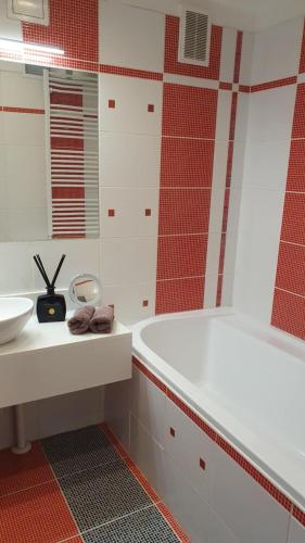 a bathroom with a white tub and a sink at Apartmán Lukas s KRBEM v centru in Karviná