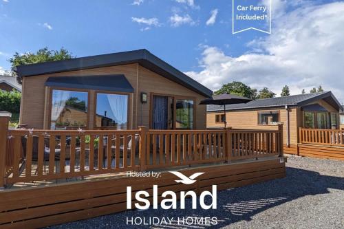 a home with a large deck and a house at Mollys Lodge in Ryde