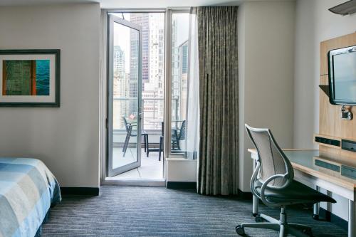 a hotel room with a bed and a sliding glass door at World Center Hotel in New York