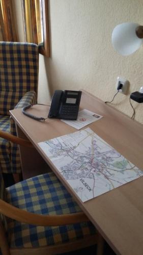 a phone sitting on a table with a map at Hotel Angerer in Vilseck