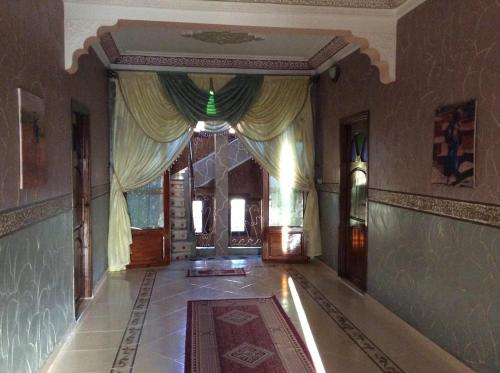 an empty hallway with curtains in a building at Hotel Espace Tifawine in Tafraoute