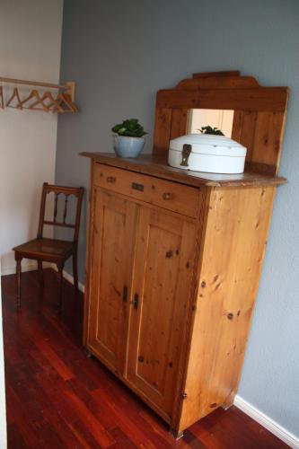 a wooden cabinet with a toaster on top of it at Bastians Herberge in Leipzig
