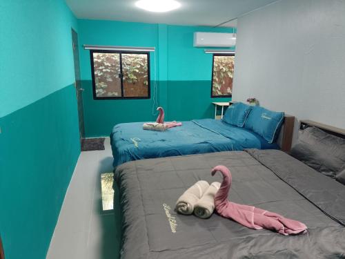a bedroom with two beds with pink flamingos on it at BP Budget Rooms in Ko Mak