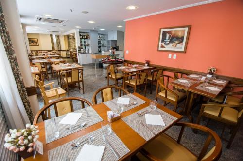 a dining room with wooden tables and chairs at Hotel OK in Rio de Janeiro