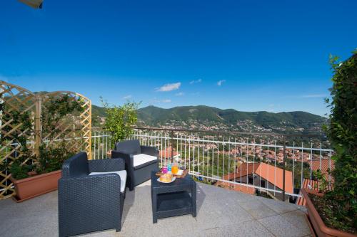 a balcony with chairs and a table with a view at Valle degli Dei in Agerola