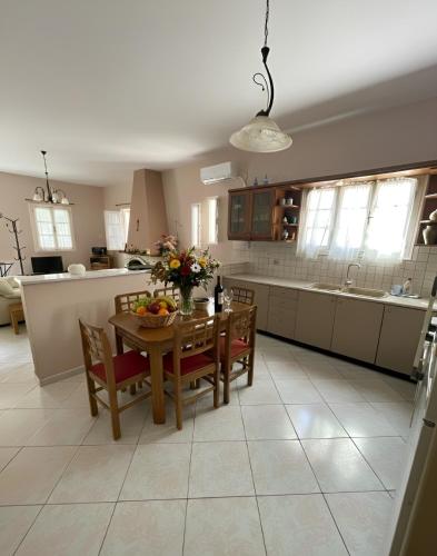a kitchen with a wooden table and chairs and a kitchen with at The Kefalonian Divarata House in Kefalonia