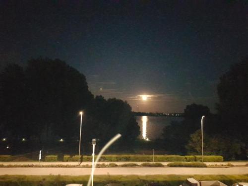 a view of a river at night with a moon at Corte Pomponazza in Mantova