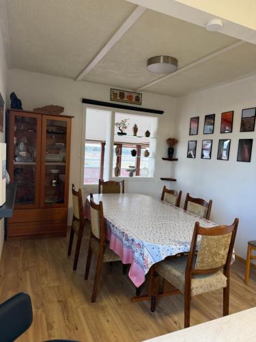 a dining room with a table and chairs at Laufás Guesthouse in Hellissandur