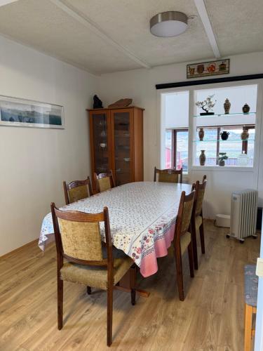 a dining room with a table and chairs at Laufás Guesthouse in Hellissandur