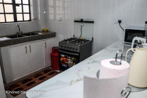 a kitchen with a stove and a counter top at Machakos Town 3 Bedroom Ensuite in Machakos