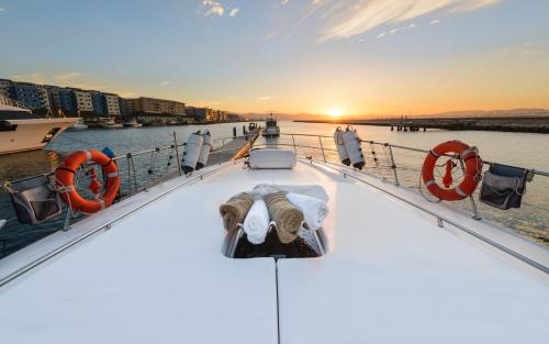 a boat in the water with the sun setting at Luxury Yacht Hotel in Gibraltar