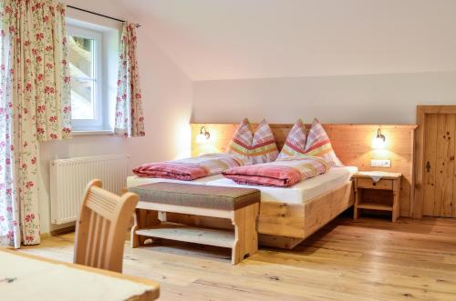a bedroom with a bed with two pillows on it at Bauernhof Krahlehen - B&B - Apartments in Filzmoos