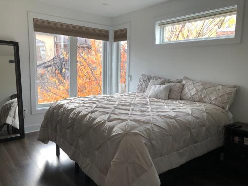 a bedroom with a bed and a large window at Upscale 3BR I Walk Score 99 I Metro I Free Parking in Washington, D.C.