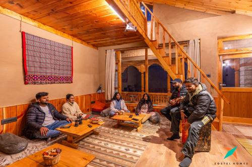 a group of people sitting in a room at Zostel Homes Laida, Jibhi in Sainj