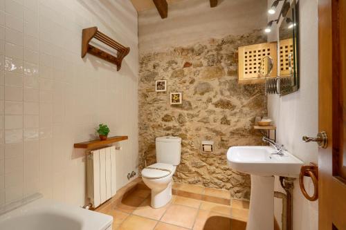 a bathroom with a toilet and a sink at Turisme Rural Mas Ramades in L'Estartit