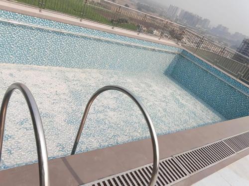 a view of a swimming pool from a balcony at Hotel Presidency in Surat