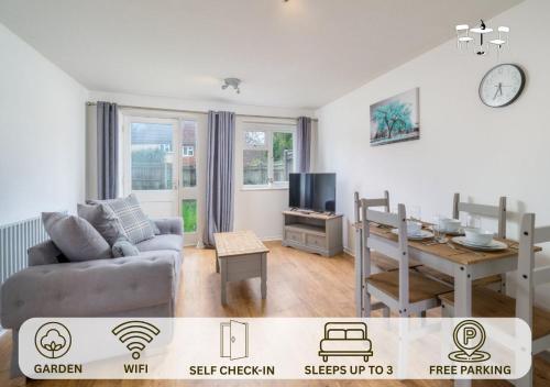 a living room with a couch and a table at Stylish Crawley 1BR with Private Garden Free Parking Near Gatwick LGW in Three Bridges
