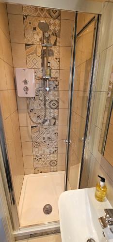 a bathroom with a shower and a sink at Ellerbrook House in Windermere
